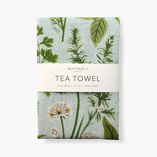 A linen tea towel with a floral and herb design