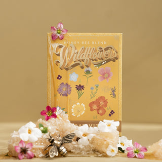 A seed packet labeled 'Honey Bee Wildflowers' with illustrations of various flowers and a bee by To & From Gift Co. 