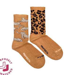 Mismatched leopard socks with words saying "it's good to be different"