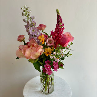 Bouquet of colourful flowers in a clear vase 