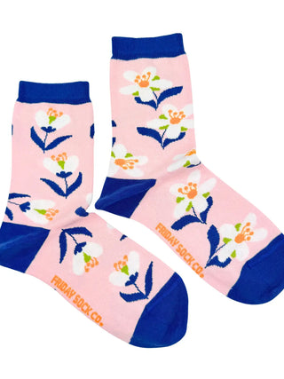 Floral-patterned socks with blue accents on a pink background