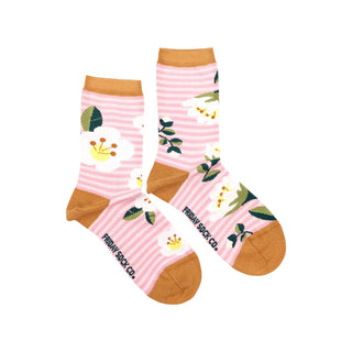 A pair of  mismatched socks with a floral pattern, including flowers